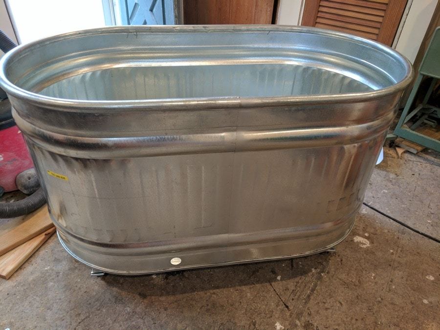 head outside to fill galvanized trough planters